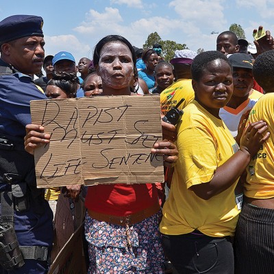 A protester holds on October 18, 2013 a placard reading 