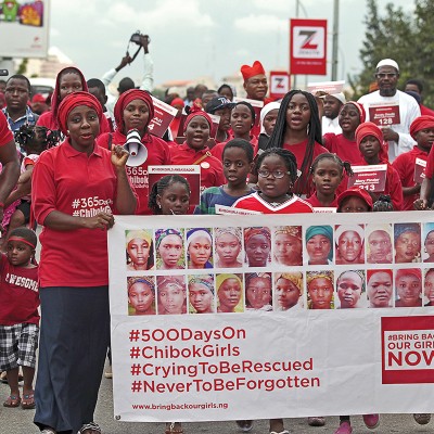 Bring Back Our Girls (BBOG) campaigners take part in a protest procession marking the 500th day since the abduction of girls in Chibok, along a road in Abuja