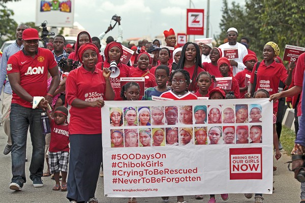 Bring Back Our Girls (BBOG) campaigners take part in a protest procession marking the 500th day since the abduction of girls in Chibok, along a road in Abuja