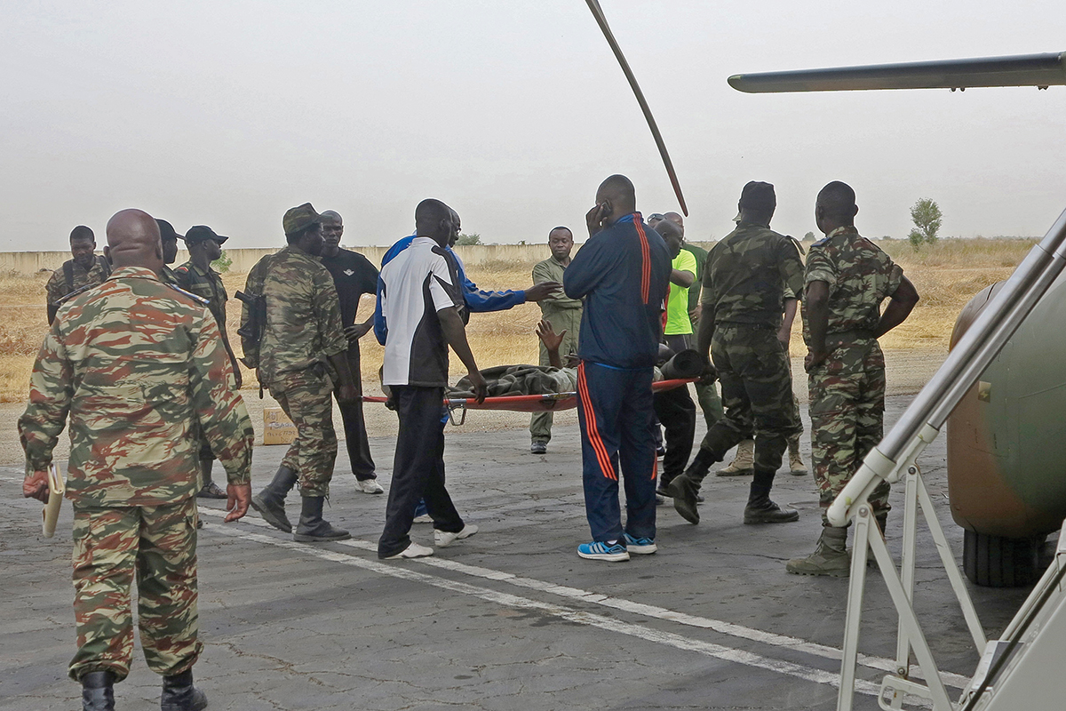 Military personnel evacuate a Cameroonian soldier