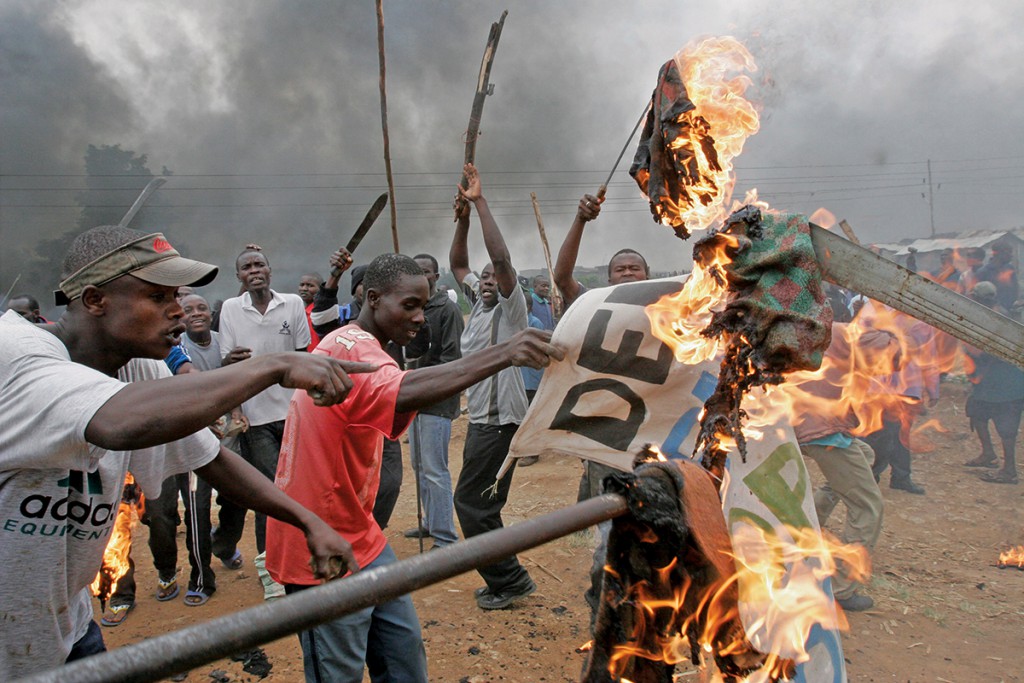 Opposition supporters burn banner