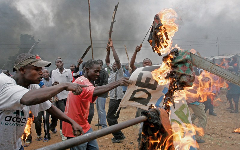 Opposition supporters burn banner