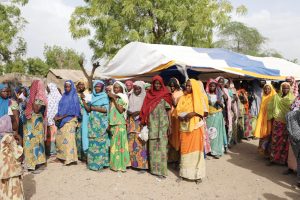 Women With Food Ration Cards Are Seen In A Queue At A Food Distribution Centre At The Banki Idp Camp In Borno