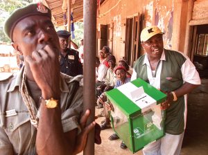 Nigerian Election Official Shows Empty Ballot Box Before Start Of A Delayed Parliamentary Poll.