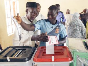 Two Men Cast Their Ballots In A Poling Station In Kano